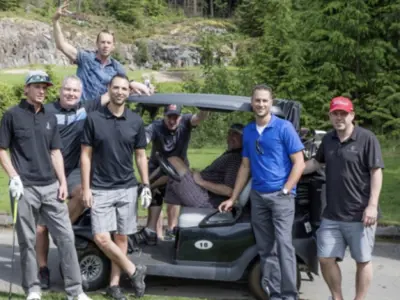 People standing in front of a golf cart
