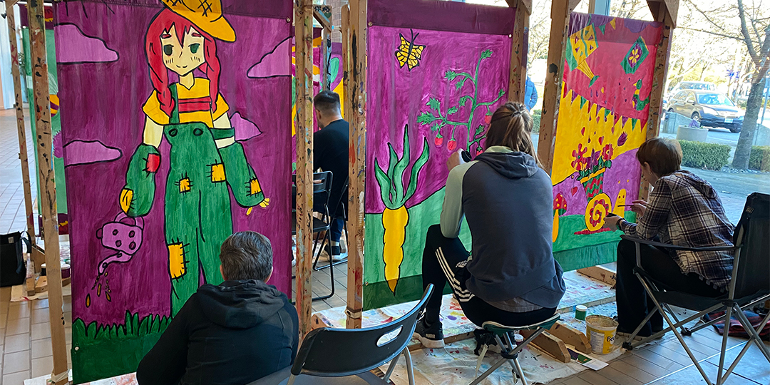 people painting street banners