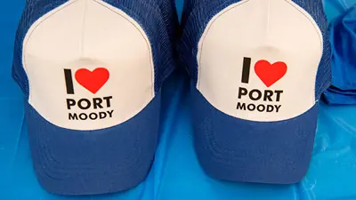 Two blue and white trucker hats that say I heart port moody
