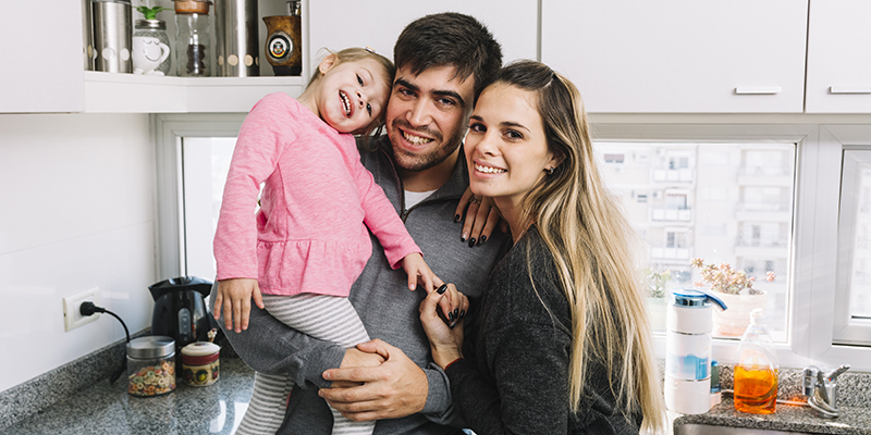 family posing in kitchen