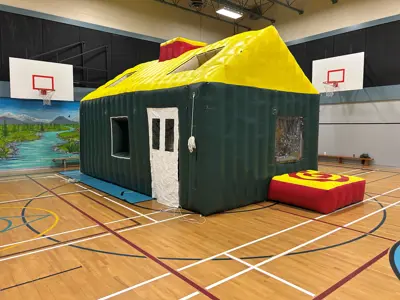 Inflatable house for fire safety training on a school gymnasium floor