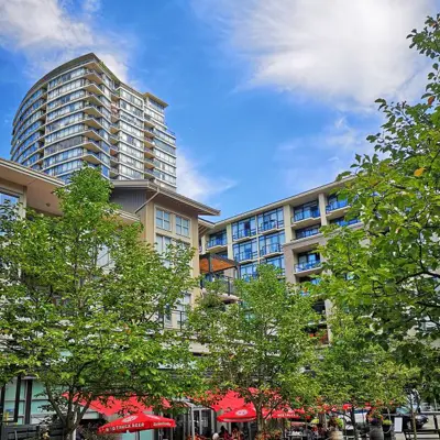Combine residential and commercial building with trees and restaurant patio