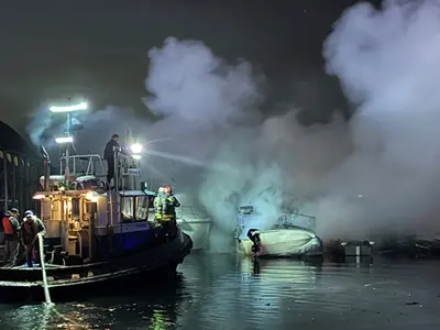 Fire crew extinguishing a boat out on the water