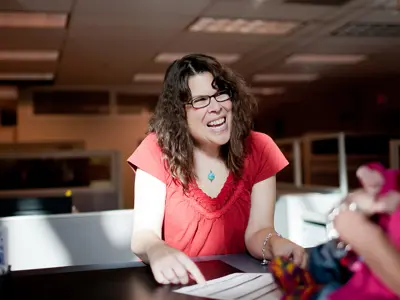 A person helping someone at the counter