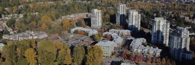 An aerial images of high and low rise buildings with fall trees