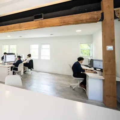 People working at desks in a bright office