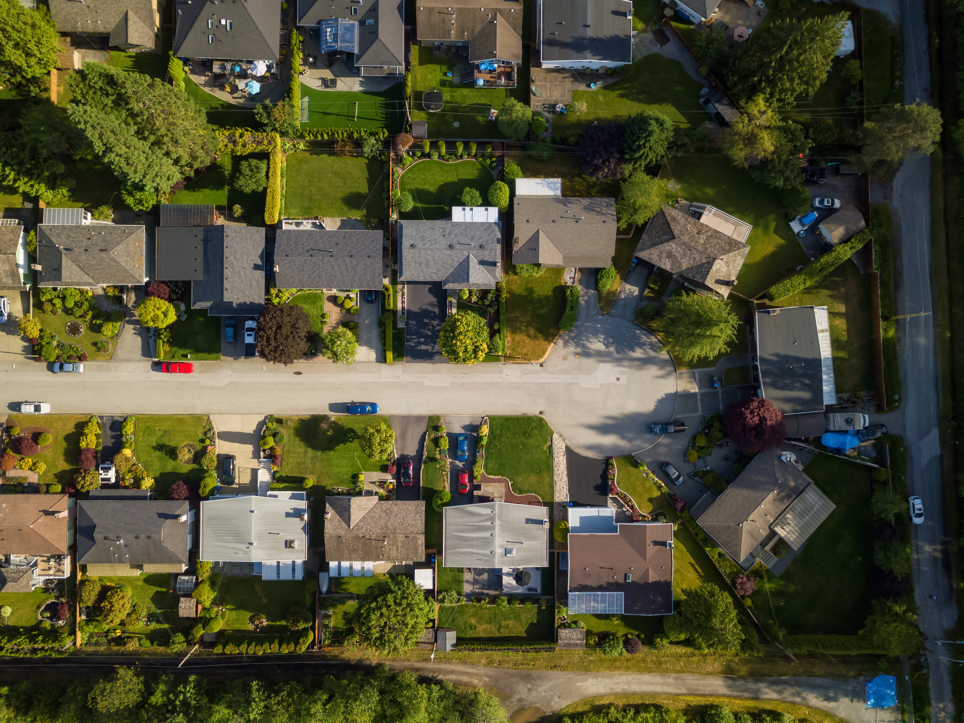 An aerial view of a street lined with houses that ends in a cul de sac