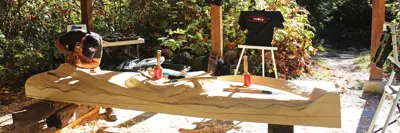 Person carving a welcome pole