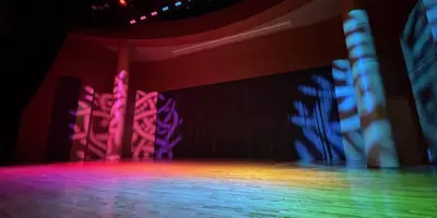 Empty stage with multi-coloured light cast