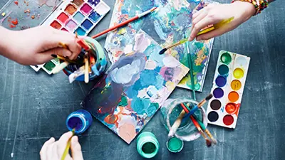 Hands painting a picture