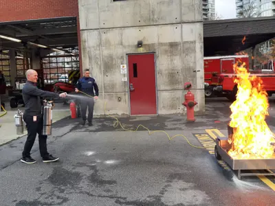 Firefighter using fire extinguisher