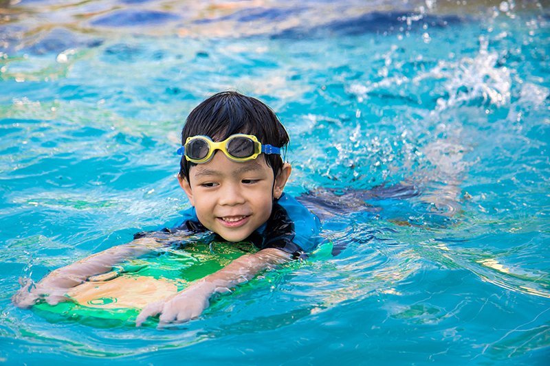 child swimming in a pool