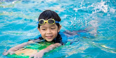 child swimming in a pool