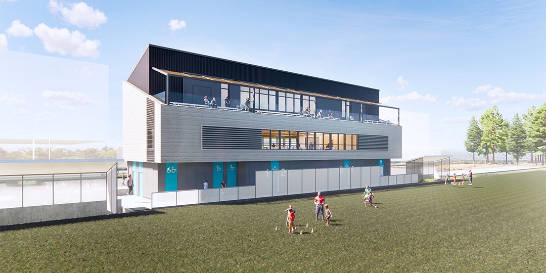 Rendering of a fieldhouse with grass and people playing soccer