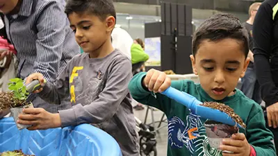 Two children planting seedlings